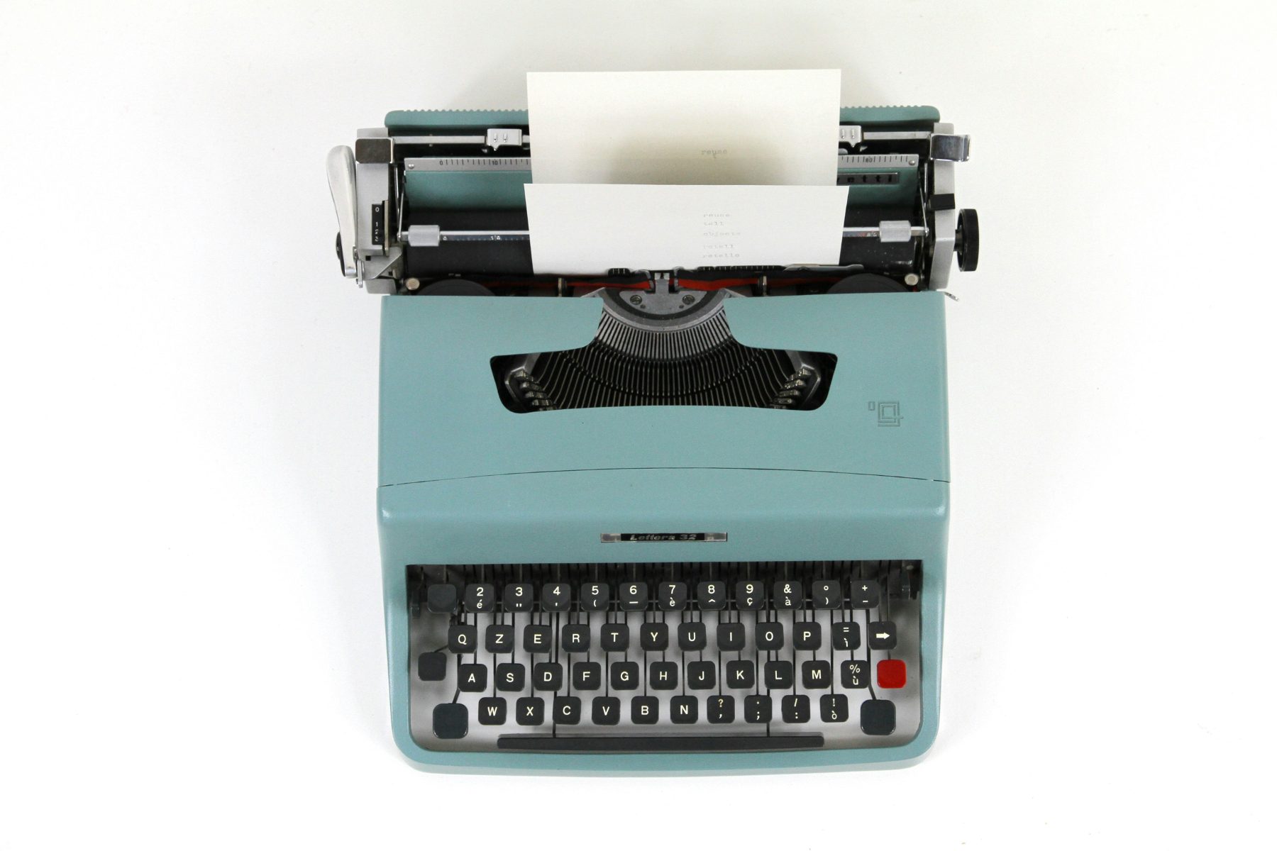 A vintage typewriter with a fresh sheet of paper